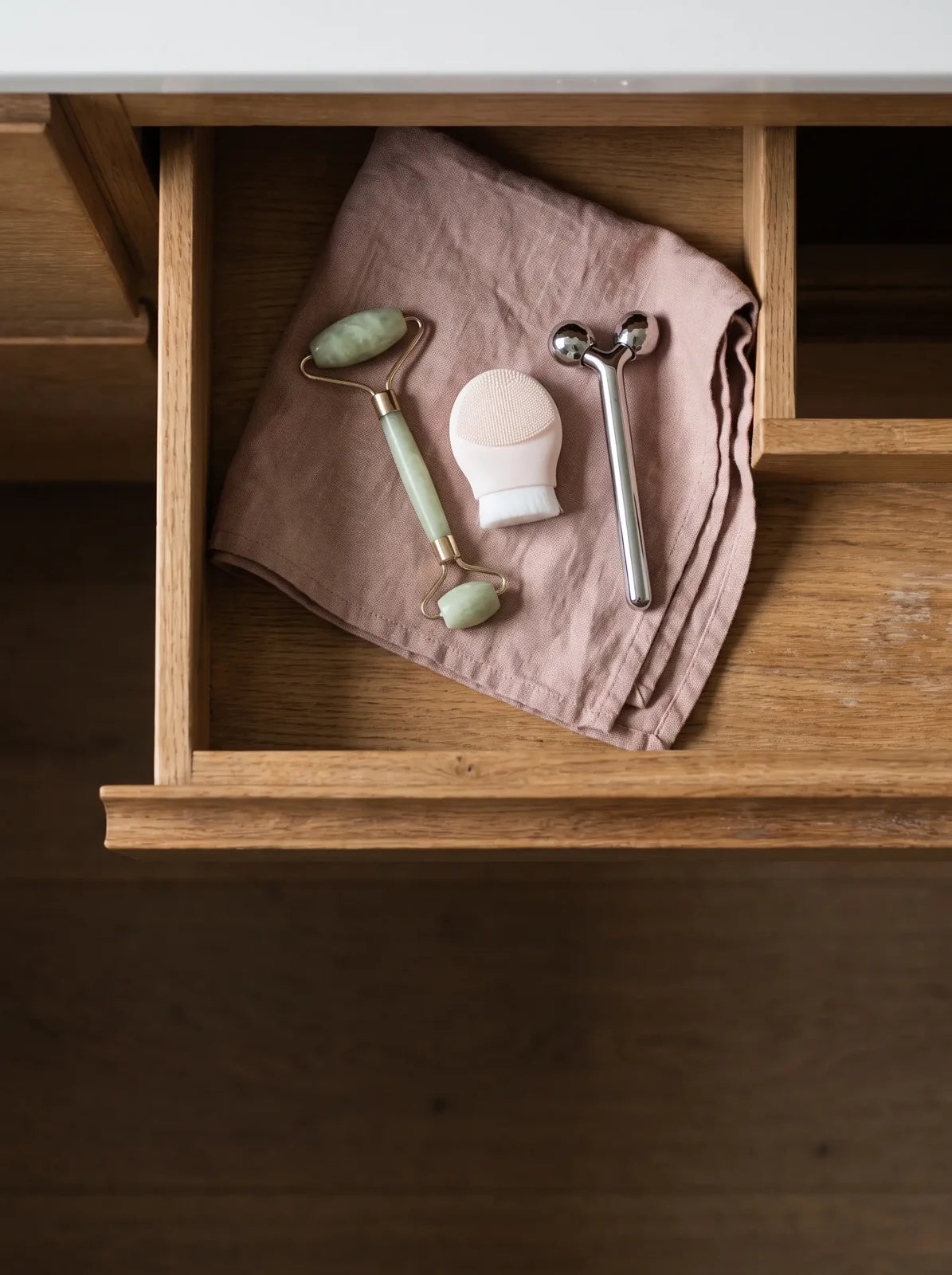 Facial tools stored in a bathroom drawer