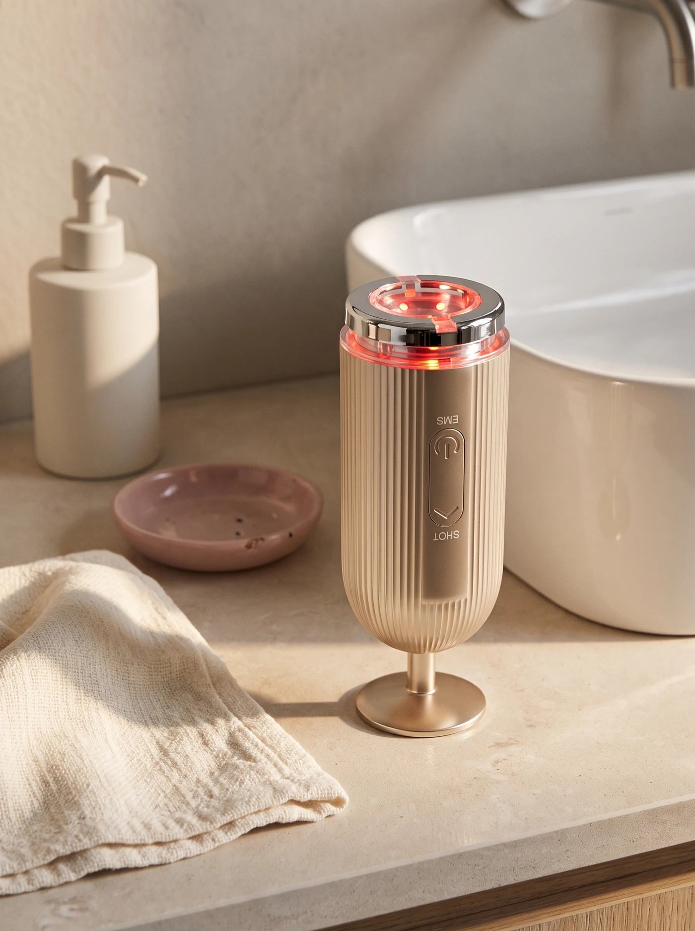 FLOW+ beside a cleanser and folded face cloth on a bathroom counter